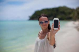 Beautiful brunette woman on the beach photo