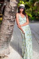 Beautiful brunette woman on the beach photo