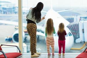 Mother and daughters on the airport photo
