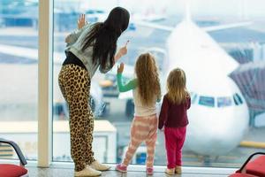 Mother and daughters on the airport photo