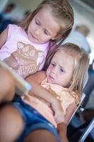 Beautiful little sisters waiting on the airport photo