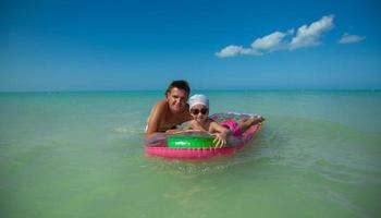 Father and daughter on the beach photo