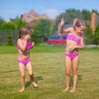Little sisters having fun in the summer photo