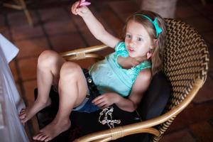 Little girl on a woven chair photo