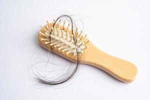 Hair loss fall with comb bush serious problem health, beauty and cosmetic concept. photo