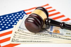 Gavel for judge lawyer and US dollar banknotes on USA America flag, finance concept. photo