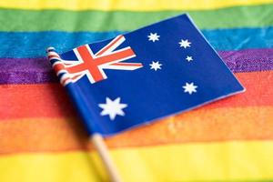 Australia flag on rainbow background flag symbol of LGBT gay pride month  social movement rainbow flag is a symbol of lesbian, gay, bisexual, transgender, human rights, tolerance and peace. photo