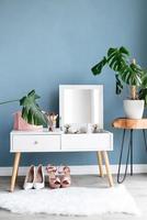 Stylish room interior with elegant dressing table and plants photo