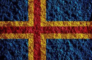 Flag of Aland Islands on a textured background. Concept collage. photo