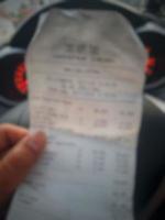 Defocused blurred photo of A hand is holding a shopping receipt