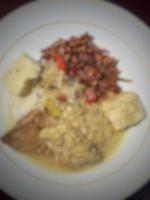 Defocused blurred photo of typical Javanese food, smoked fish mangut rice with orek tempeh added.