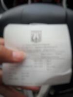 Defocused blurred photo of A hand is holding a shopping receipt