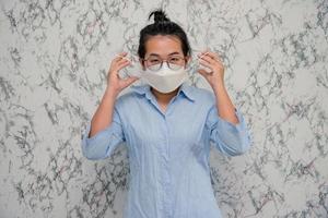 elegant womanman wearing a mouth protection to prevent getting sick at work or on the way to work  isolated on White background, pandemic and social distancing concept.Covid-19 photo