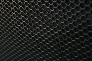 Black iron speaker grid texture. Industrial background photo