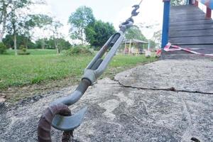 selective focus on metal lanyards and hooks used to pull and strengthen wire slings that hold up bridges or building construction photo