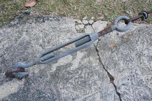 selective focus on metal lanyards and hooks used to pull and strengthen wire slings that hold up bridges or building construction photo