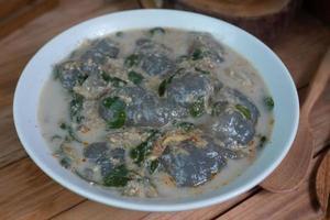 selective focus on food kapurung is a soup with a slightly sour and fresh taste originating from Sulawesi, this food is made from sago flour or starch with fish water broth, soft focus photo