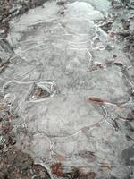 Cracked ice texture on the ground in grey tone photo