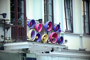 Artistic colorful loudspeakers on the balcony of the second floor on the street of Vilnius photo