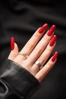 Hands of a young girl with red  manicure on nails photo