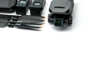 Drone and propeller blades on blur drone LiPo rechargeable battery. UAV or unmanned aerial vehicle. Quadcopter drone aircraft with a digital camera. Drone accessories. UAV carbon fiber propellers. photo