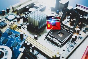 Chip shortage and US-China trade conflict. Global chip shortage crisis and China-United States trade war concept. China flag and US flag on computer on chip elctronic circuit board. Computer hardware. photo