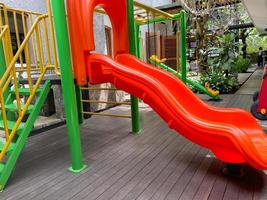 Colorful playground made of plastic empty outdoor playground set playground equipment.Garden equipment. Children's slide. School yard. Playground in the park. photo