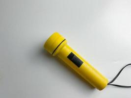 yellow flashlight on white background. copy space. flashlight for blackout and emergency. selected focus photo