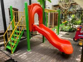 Colorful playground made of plastic empty outdoor playground set playground equipment.Garden equipment. Children's slide. School yard. Playground in the park. photo