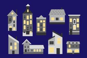 A set of flat style night city houses. Cute city and country houses with windows with lights on. Vector illustration. Blue isolated background.