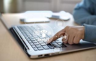 Man using Laptop and touch bar Chat bot Chat with AI, Artificial Intelligence, System Artificial intelligence an artificial intelligence chatbot, Digital chatbot, Robot application, conversation photo