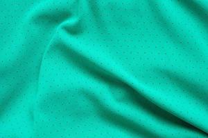 Green sports clothing fabric football shirt jersey texture background photo