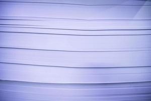 stack of paper in blue tone, note shallow depth of field photo