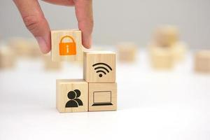 Hand holding a wooden block cube with lock icon symbol. Business strategy and target of business. photo