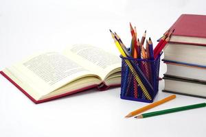 stack of books and blur pencil on white background. Knowledge and education concept. photo