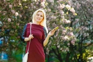 A portrait of a smiling beautiful woman texting with her phone photo