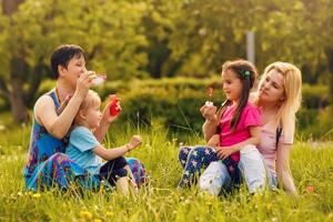 female child blow soap bubbles outdoor photo