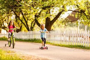 A group of happy children safely riding their bicycle on the street photo