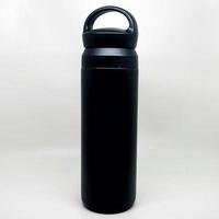 Close-up of black reusable steel metal thermo water bottle, isolated on white background photo