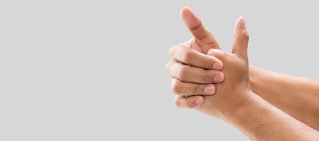 A man cracking their knuckles, On a gray background. photo