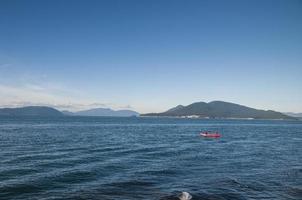 Rowing a red boat on a windy day photo