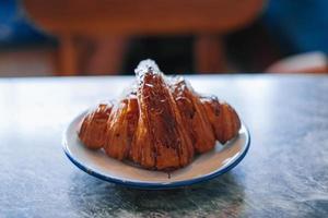 Croissant in a white small plate photo