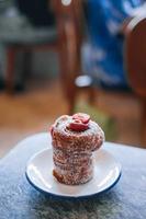 Close up of Cruffin or Kraffin in a small white plate with bokeh photo
