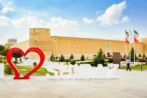 Shiraz, Iran - 10th june - 2022 - Shiraz sign with fortress panorama and tourist photo