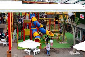 Batu-Indonesia, January 2, 2023. Selective focus of a group of people who are on the playground as well as eating at Eco Green Park. photo