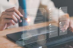 Businessman Audit online documents, quality assessment management With a checklist, business document evaluation process, market data report analysis and consulting, plan review process. photo