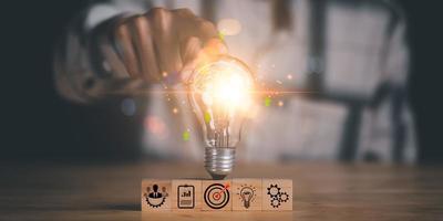 solution concept and demonstrating leadership strategies ,that lead the business in a successful direction ,with innovation and brain power from brainstorming ,man pointing at a light bulb photo