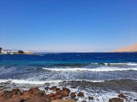 The mesmerizing view of the deep blue waters of Haql Beach in Saudi Arabia. photo