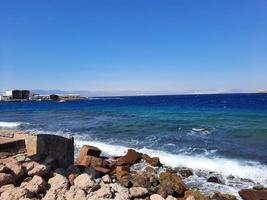 The mesmerizing view of the deep blue waters of Haql Beach in Saudi Arabia. photo