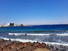 The mesmerizing view of the deep blue waters of Haql Beach in Saudi Arabia. photo